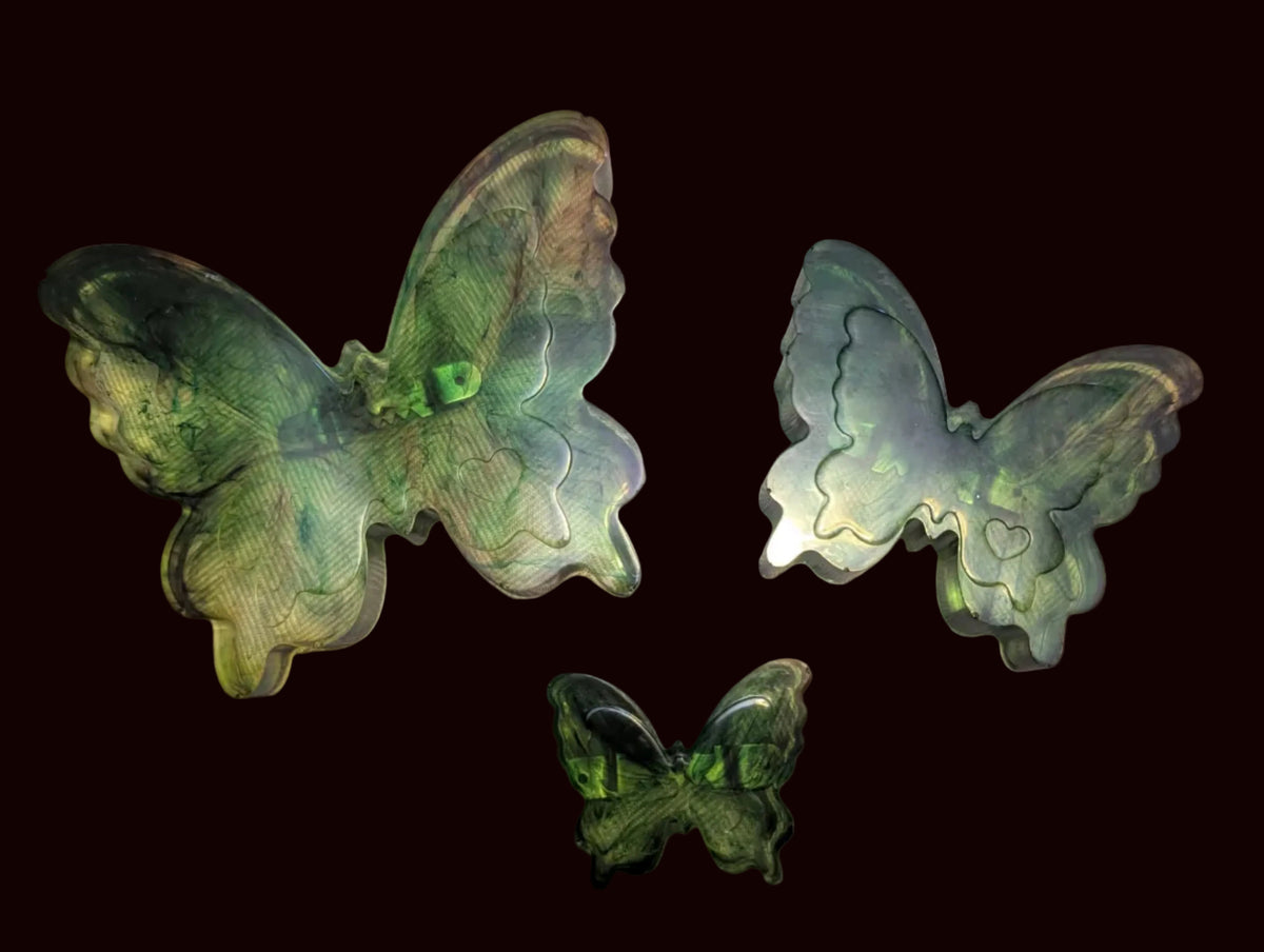 Three butterfly-shaped translucent green wall decor