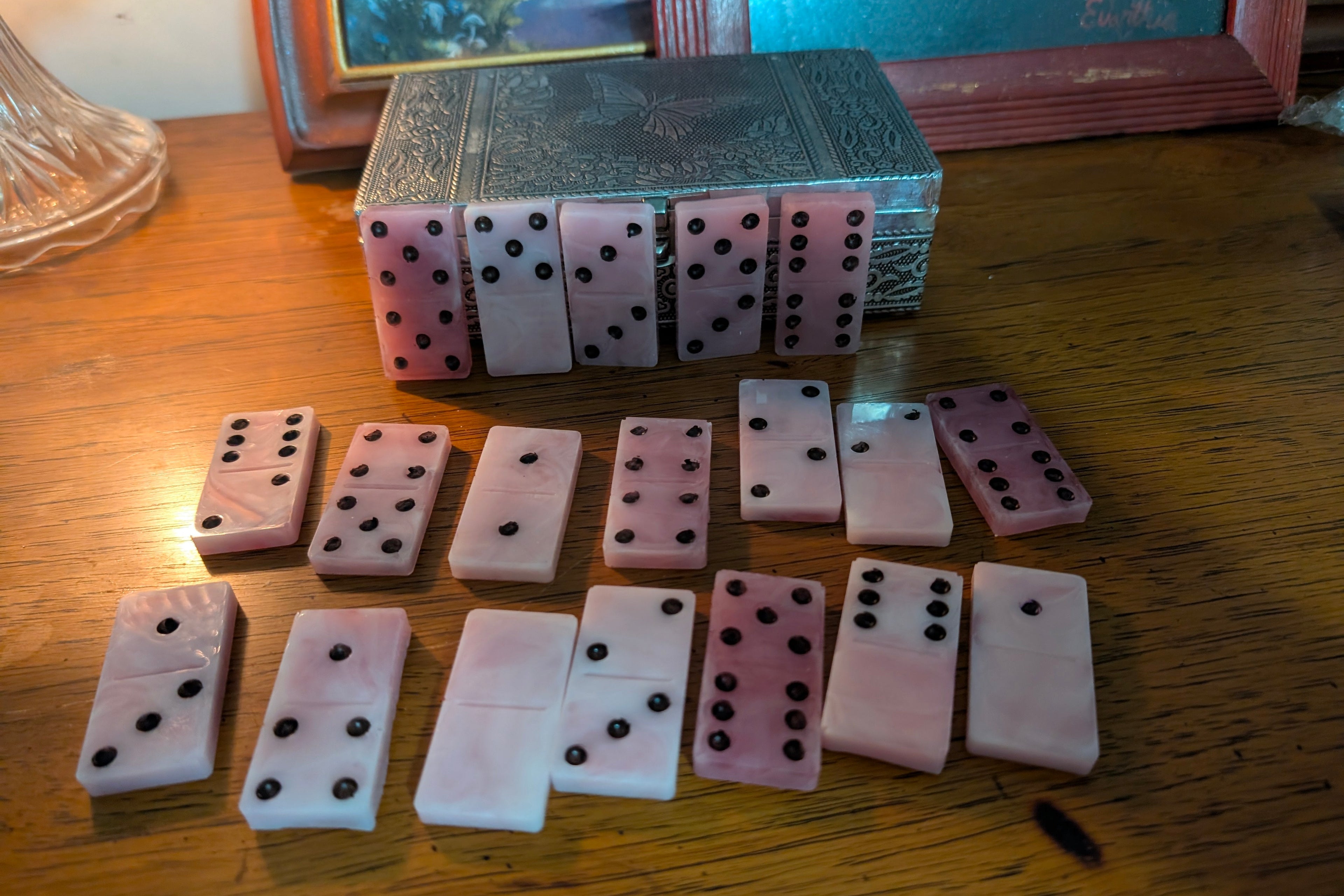 Handcrafted pink swirl resin domino set- 28 pieces elevate game night with this one of a kind domino set, handmade and poured by me in soft pink resin with dreamy swirl details. Each of the 28 full size dominoes features deep black pips for easy play and a smooth, glossy finish that feels great in your hands. The marbled pink pattern means no two sets are ever exactly alike. Perfect for gifting or for adding a pop of color to your game shelf. Comes complete with all standard domino values from blank to doub