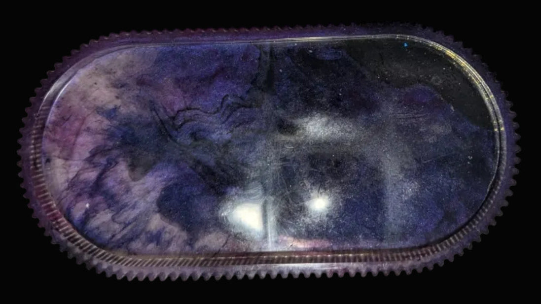 Black and purple swirl oval tray with ridged edges, perfect for small trinkets.