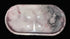 An oval-shaped clear resin tray with a pink and white marble pattern and a textured pink border